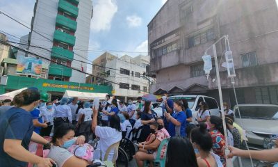 Patients and health workers outside Ospital ng Sampaloc