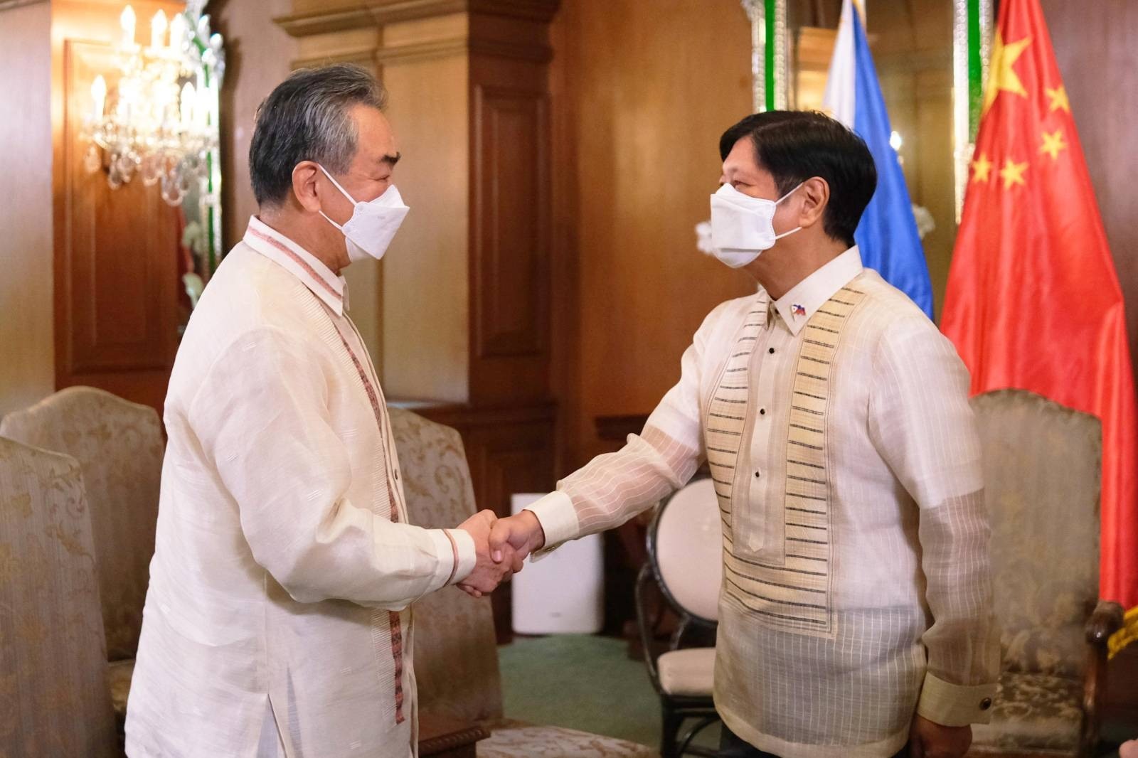 President Bongbong Marcos shakes hands with Chinese Foreign Minister Wang Yi