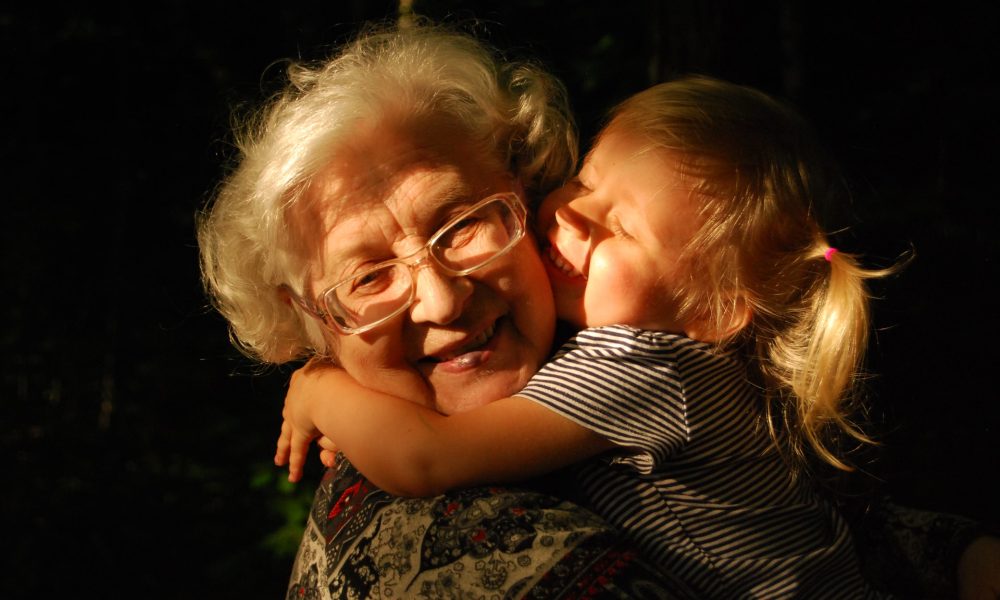 girl hugging grandmother