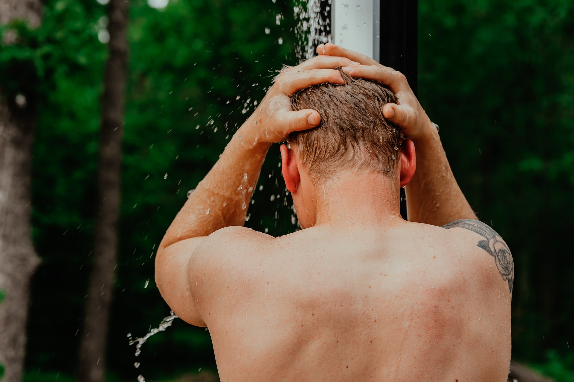 man taking shower outside