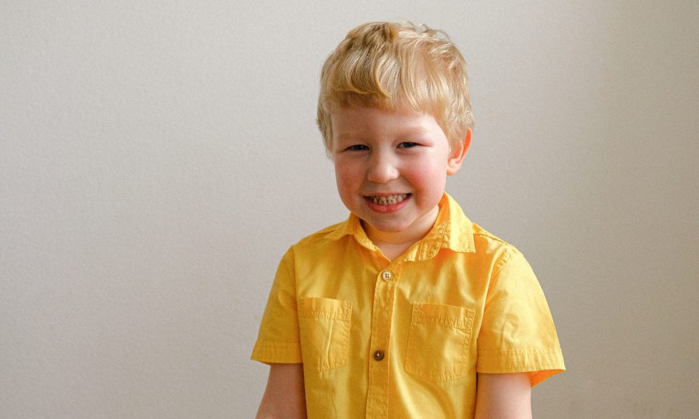 boy wearing yellow polo