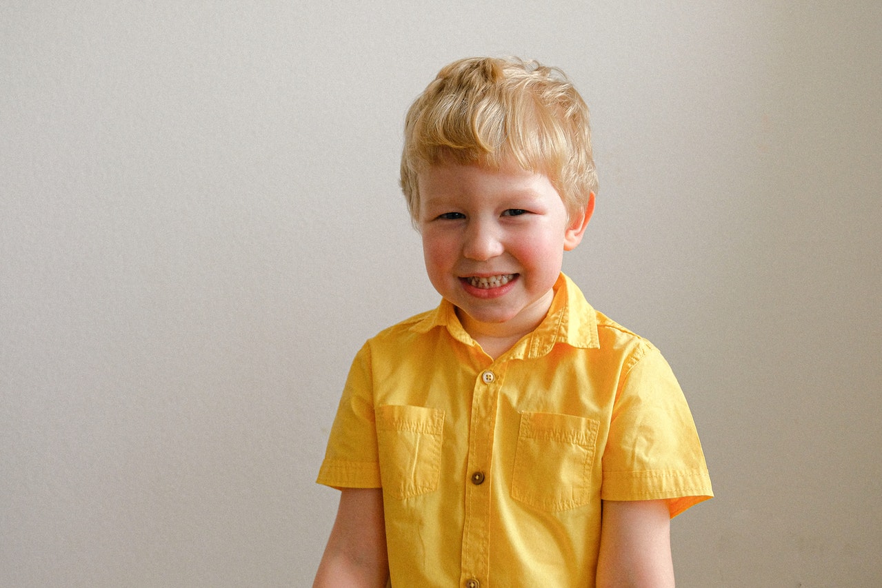 boy wearing yellow polo