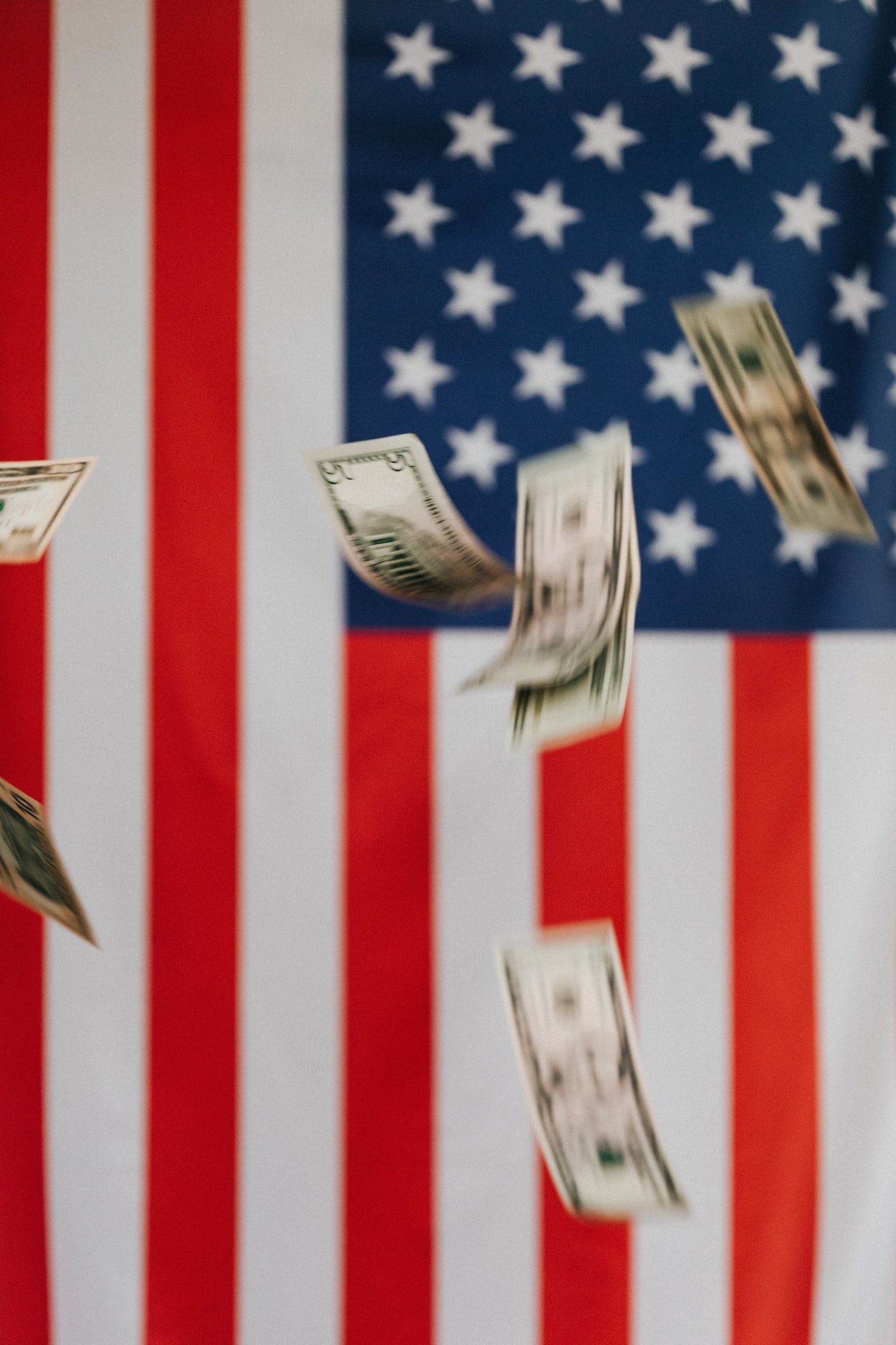 flying dollars and usa flag background