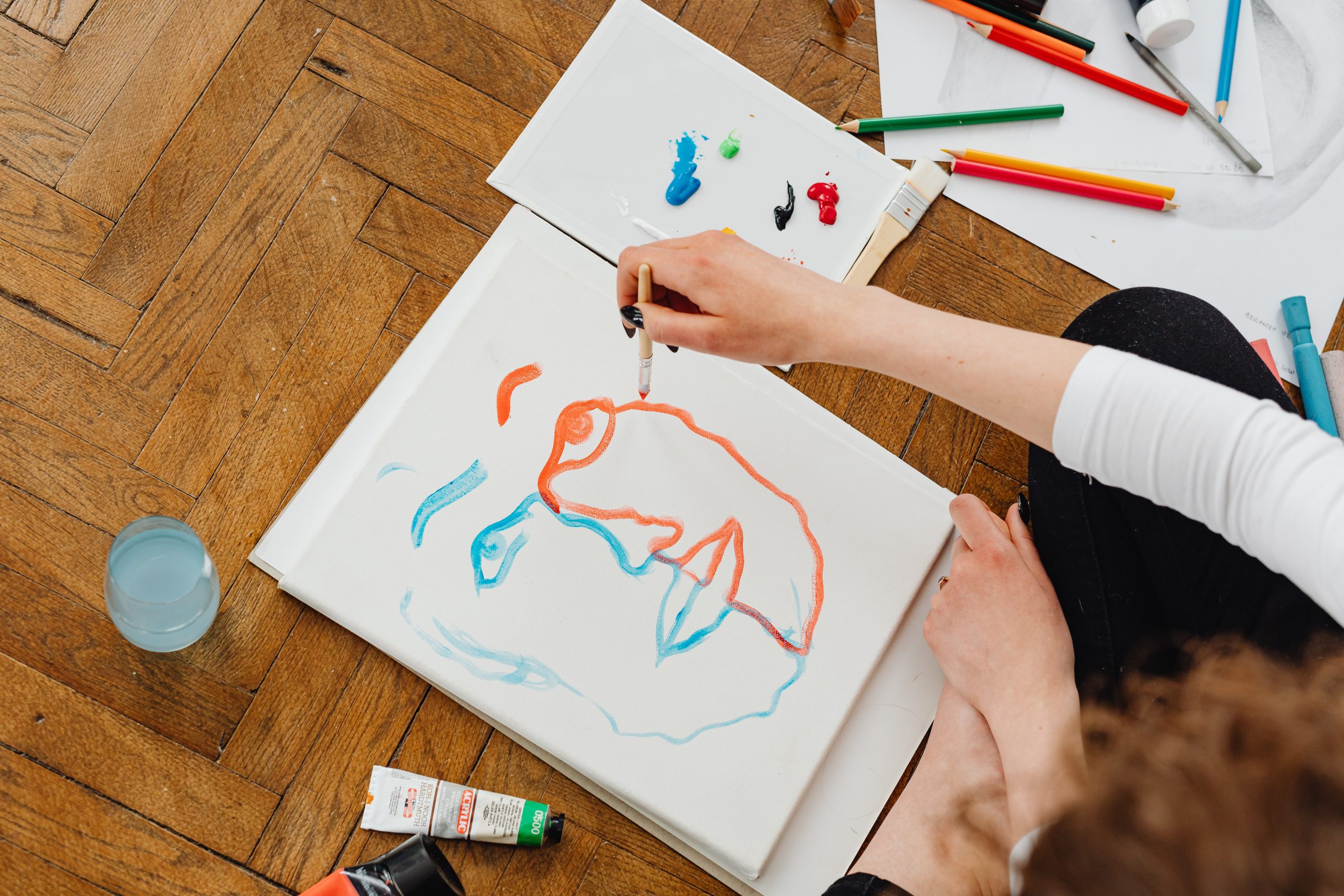 Person Painting while Sitting on the Floor