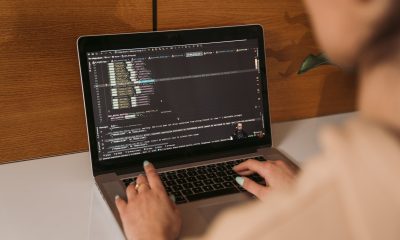 person coding on laptop