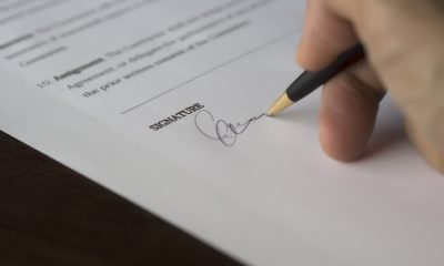 Person signing on paper