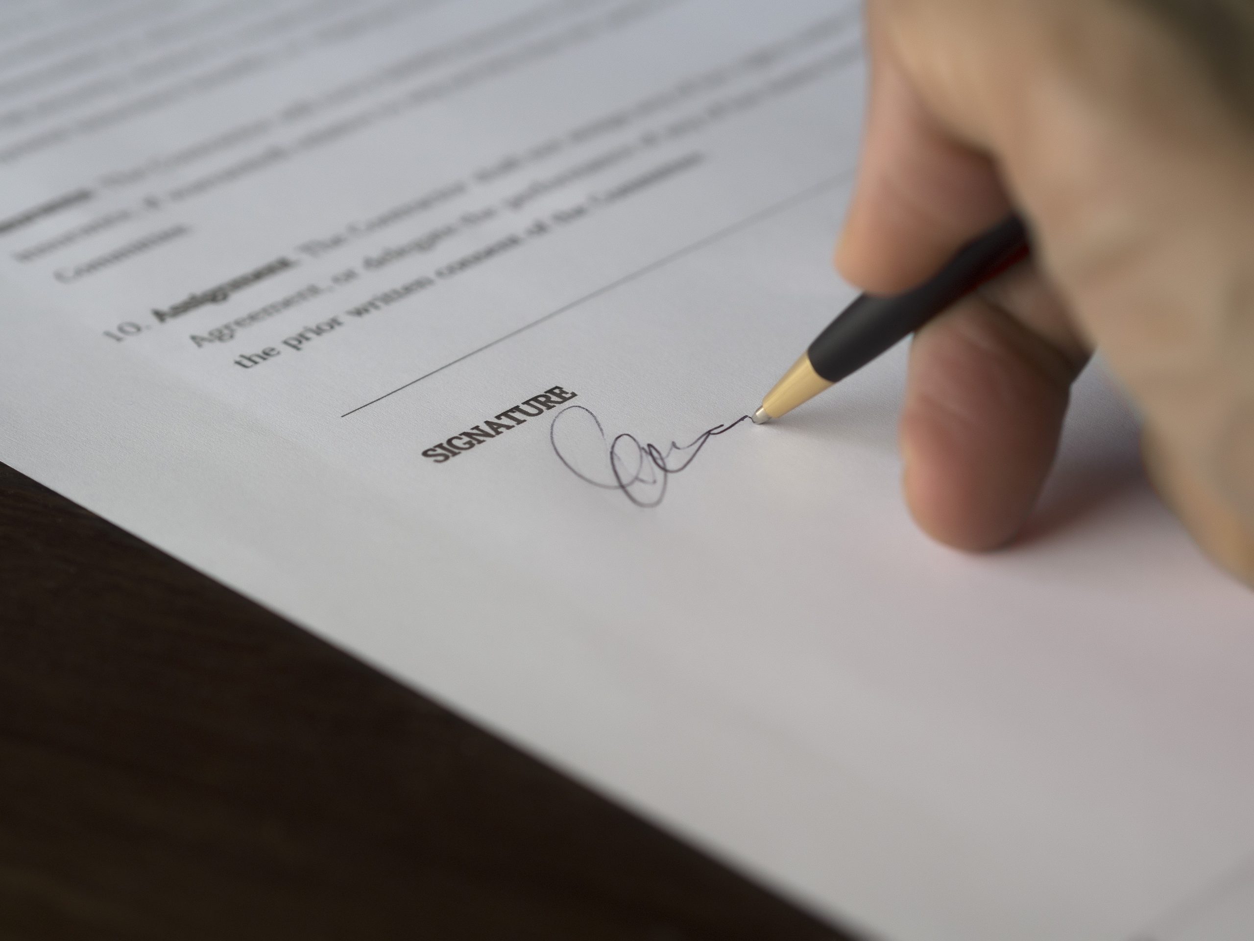 Person signing on paper