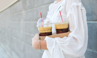 girl holding drinks with straws