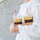 girl holding drinks with straws