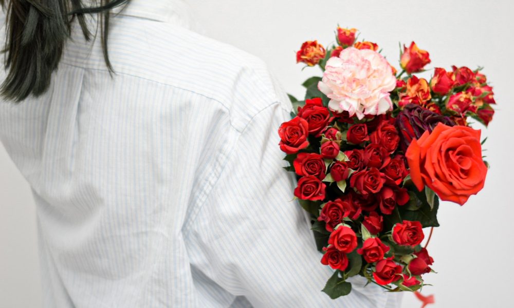 girl holding red flowers