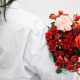 girl holding red flowers