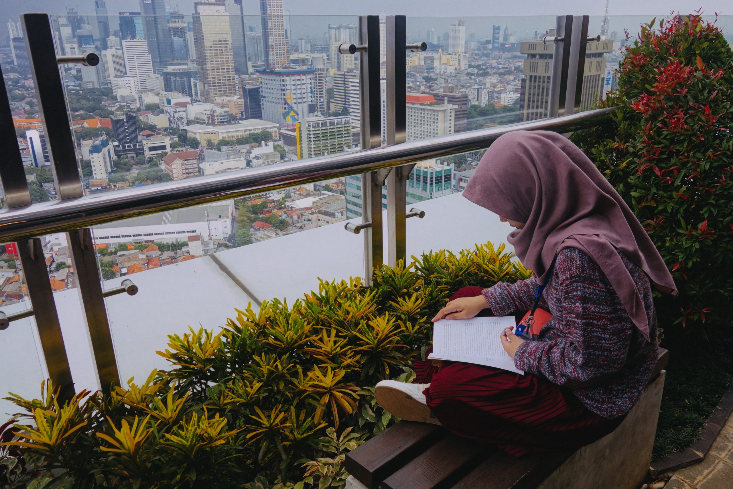 Girl reading a book on rooftop