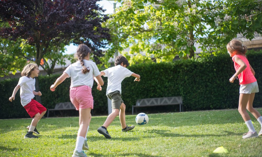 Kids Playing Football on the Field