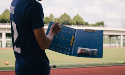 Man in blue shirt standing on field