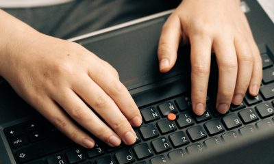 Person Typing on Black Laptop Keyboard
