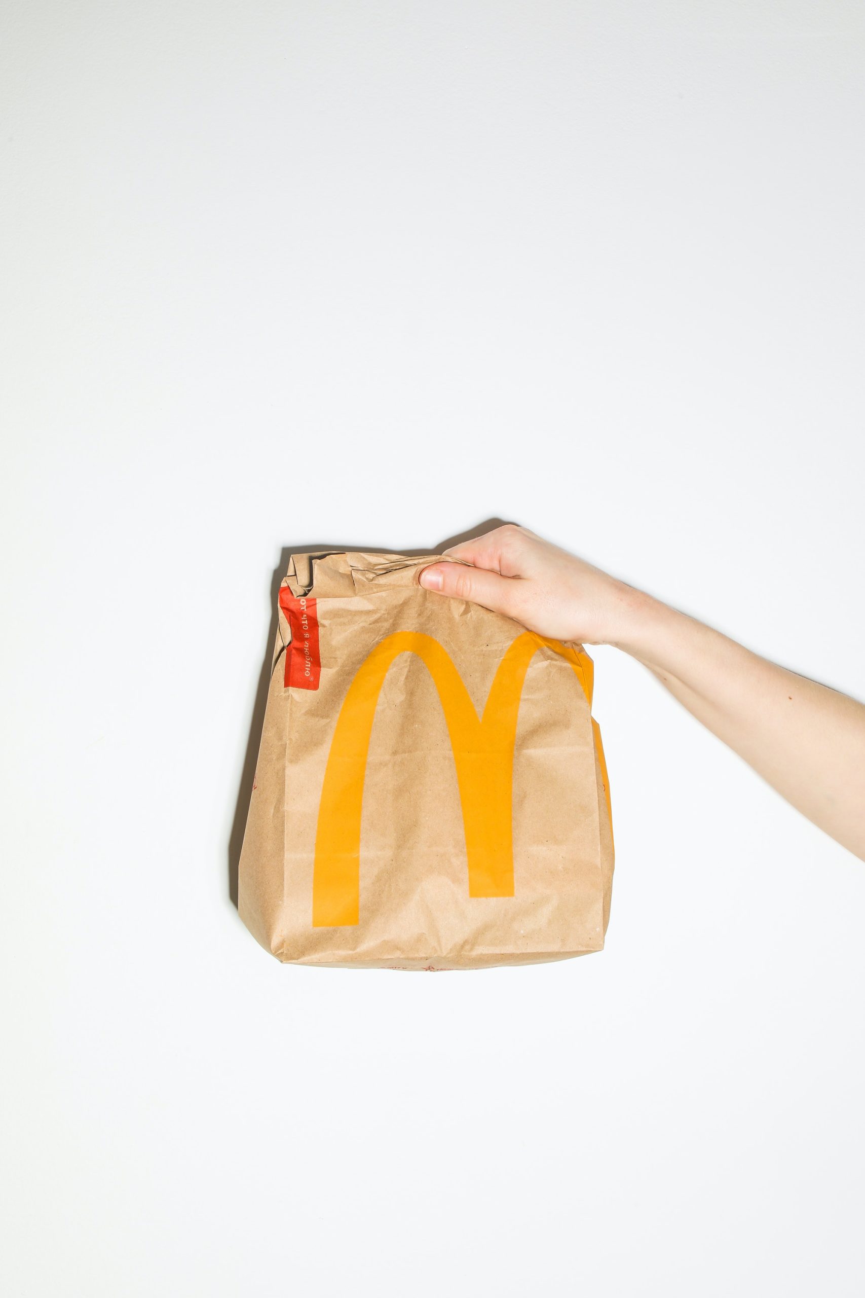 Person holding a McDonald's paper bag