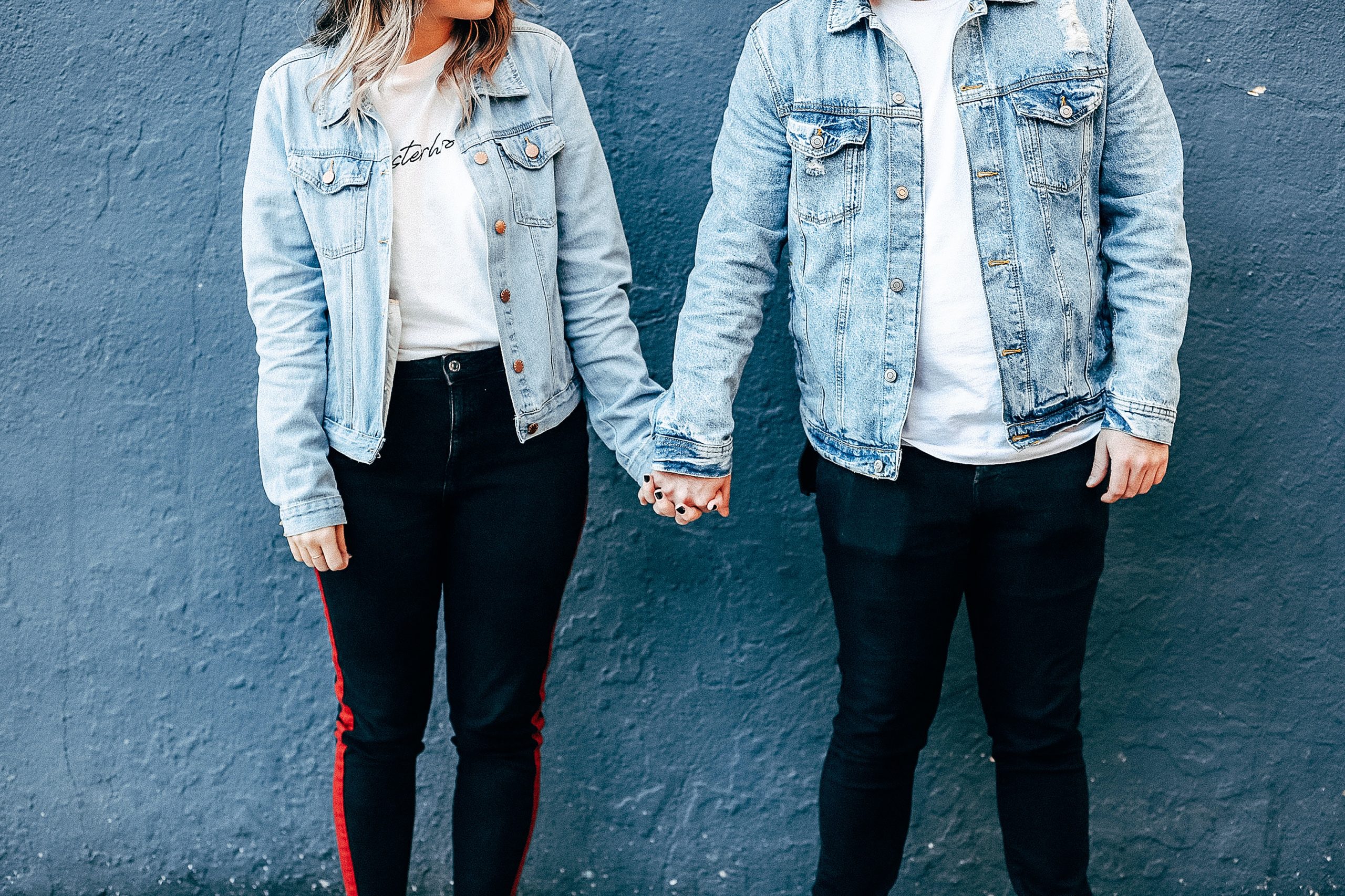 Two Person Standing and Holding Their Hands