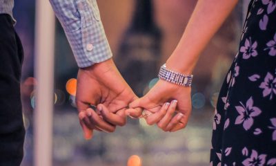 Two persons holding hands