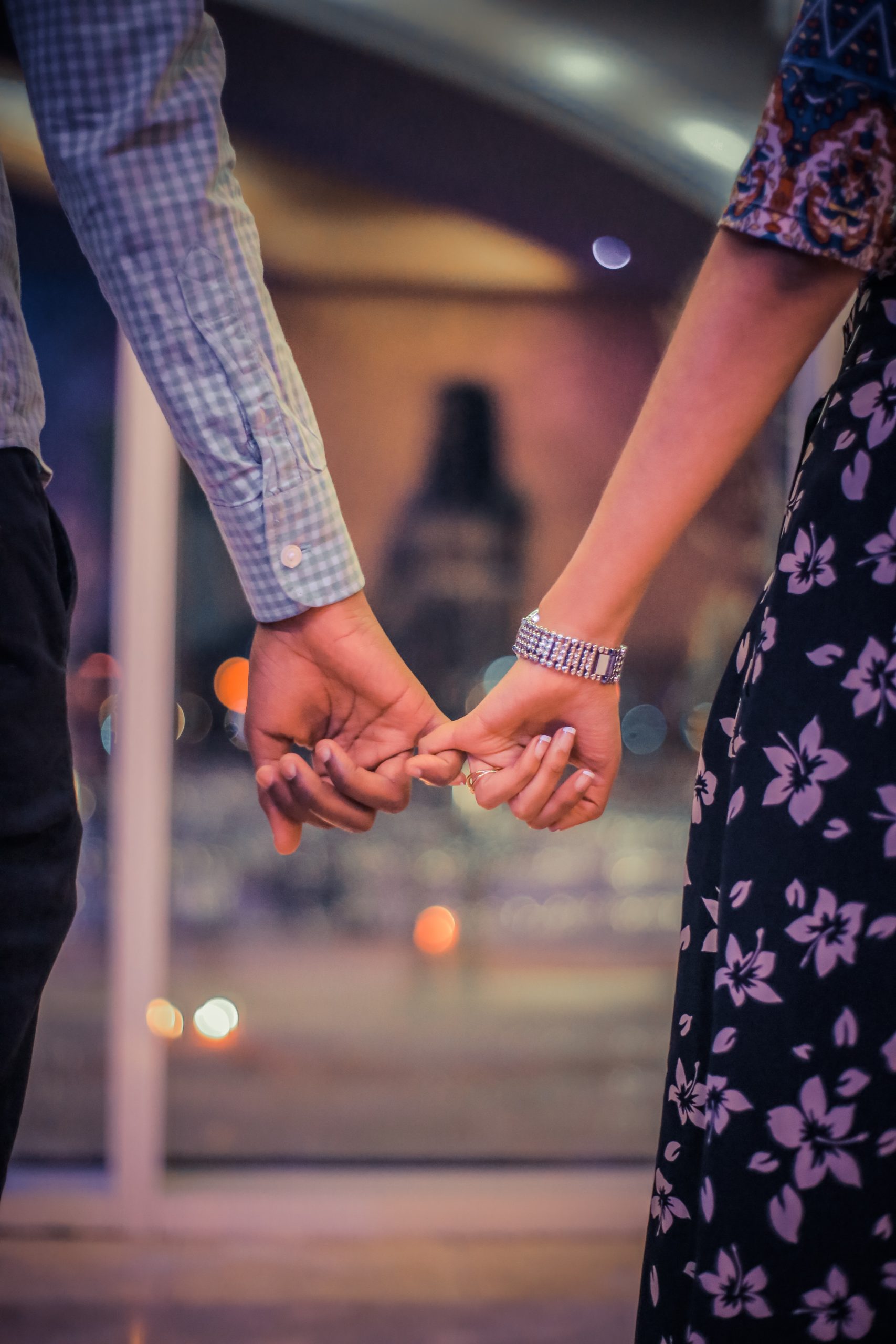 Two persons holding hands