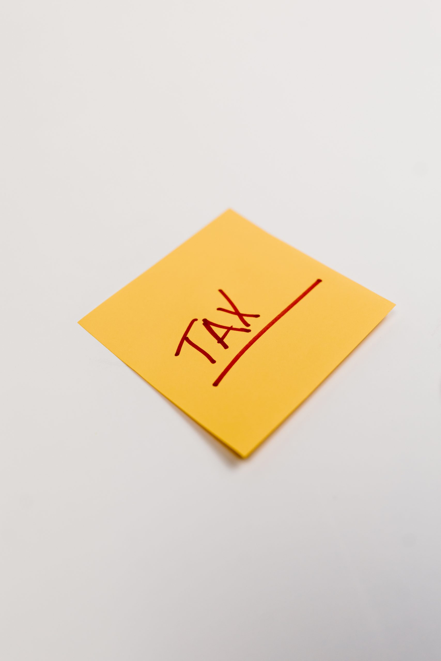 Yellow sticky note which read Tax