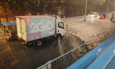 trucks through flood in Manila