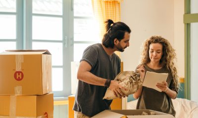 couple unpacking boxes in new home