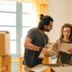 couple unpacking boxes in new home