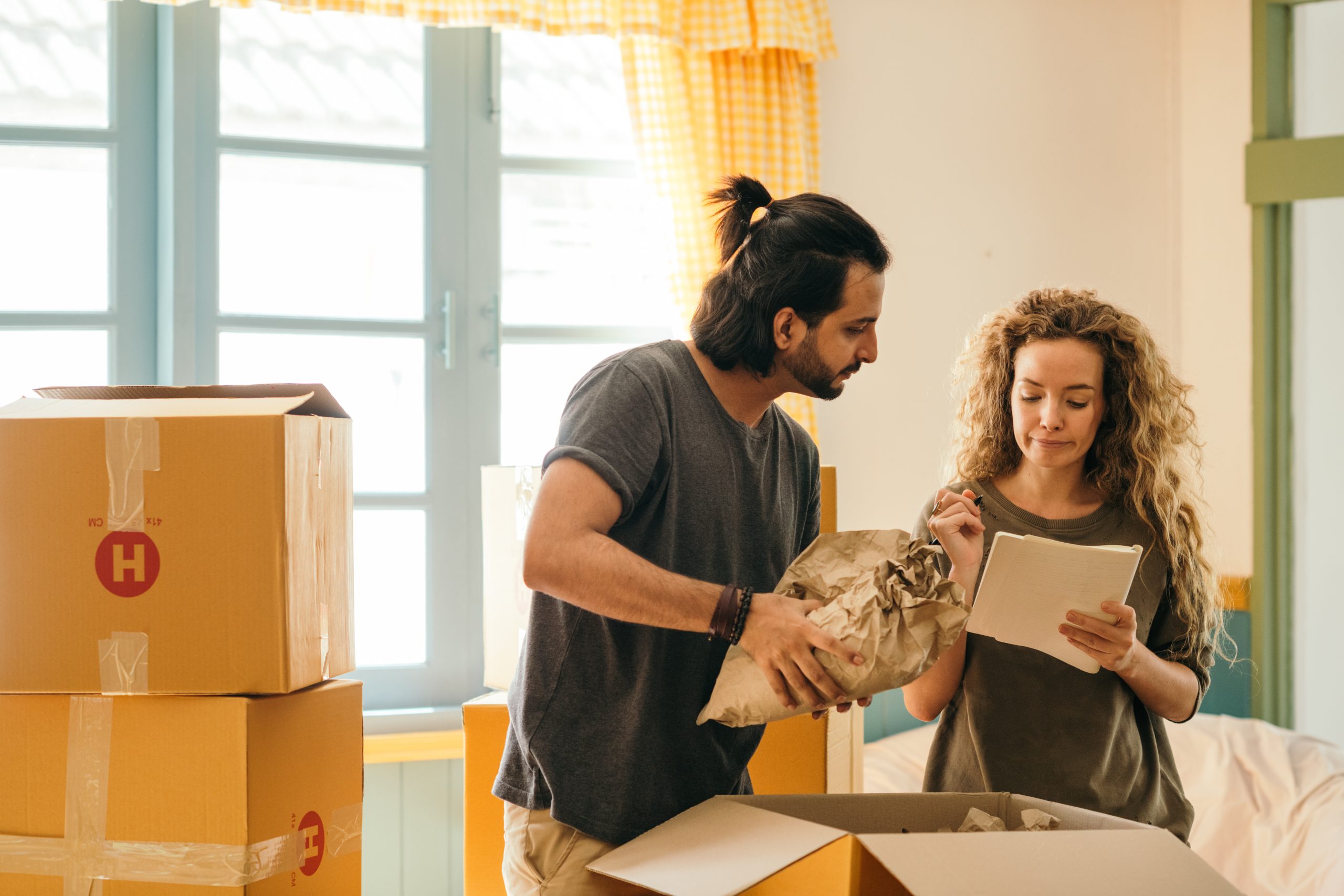 couple unpacking boxes in new home