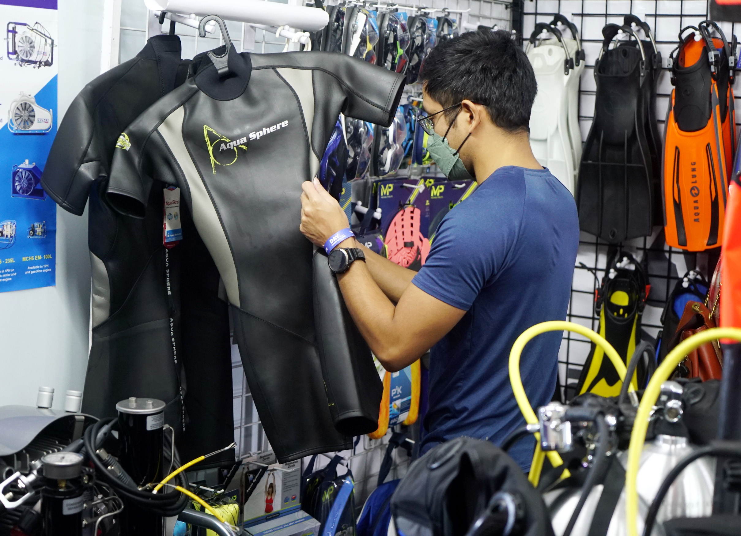 diving enthusiast checks gears and apparel