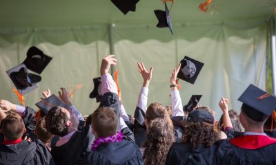 graduates throwing their caps