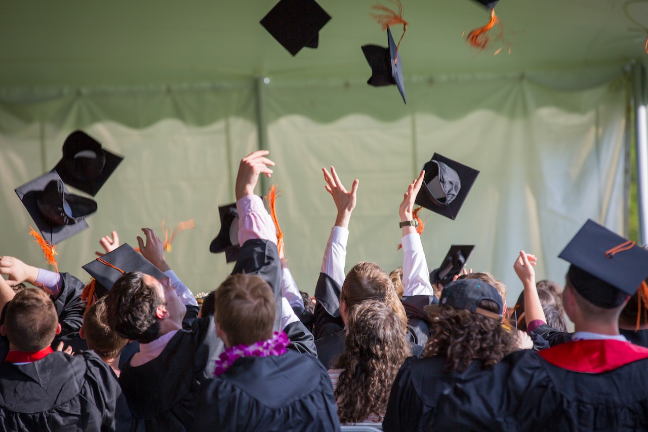 graduates throwing their caps