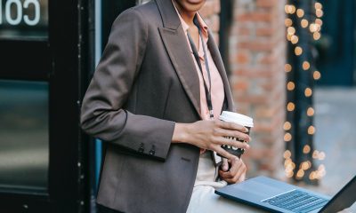 smiling businesswoman with laptop and coffee