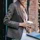smiling businesswoman with laptop and coffee