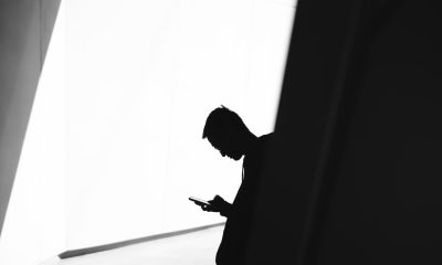 silhouette of a man using a phone