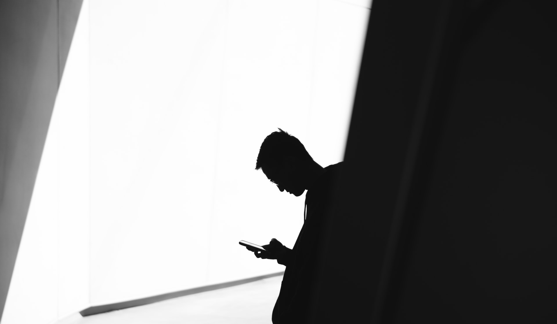 silhouette of a man using a phone