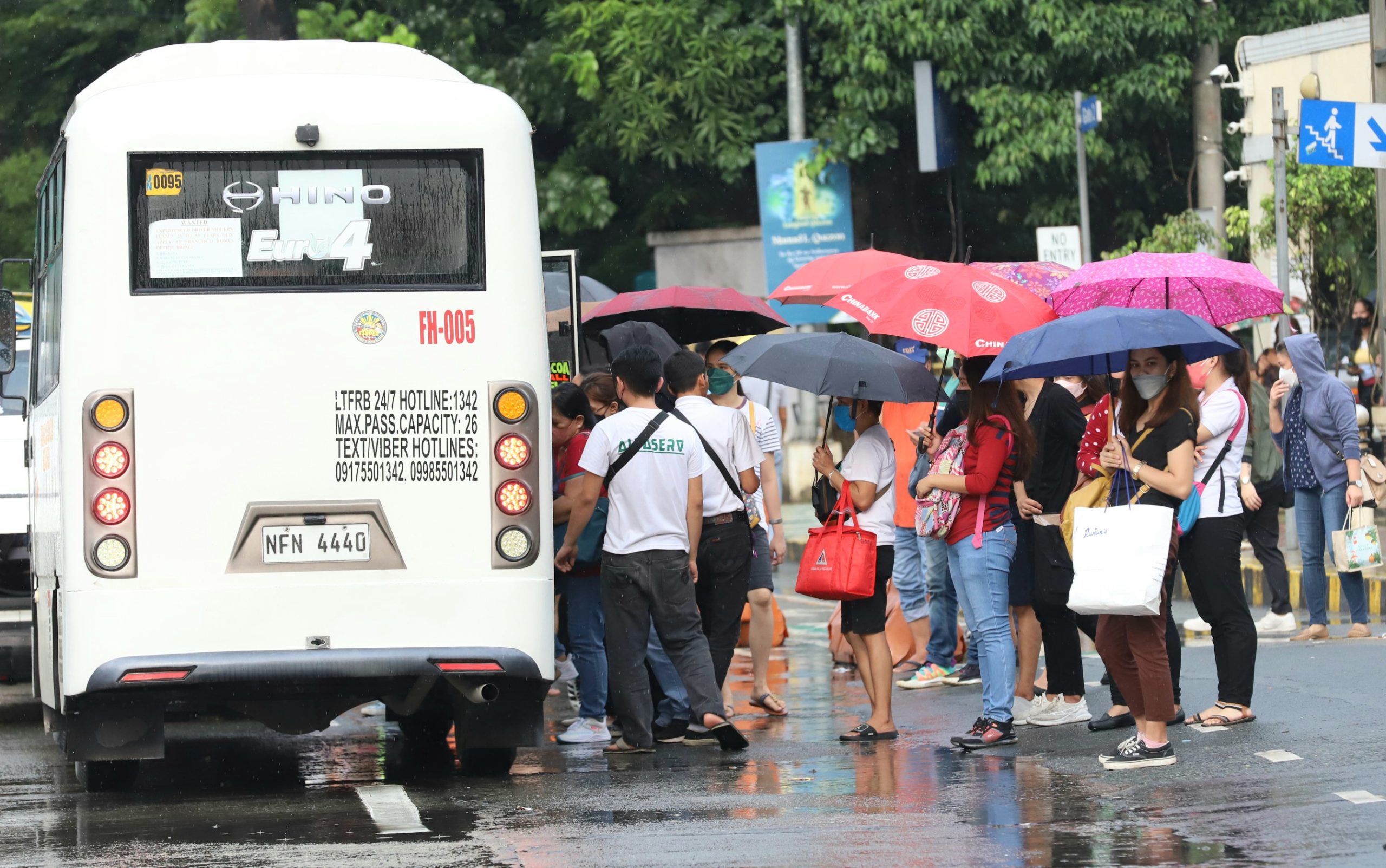 Commuters board an e-jeepney