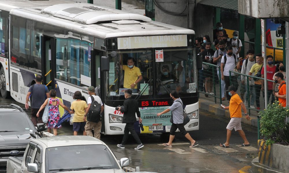 Passengers board the bus