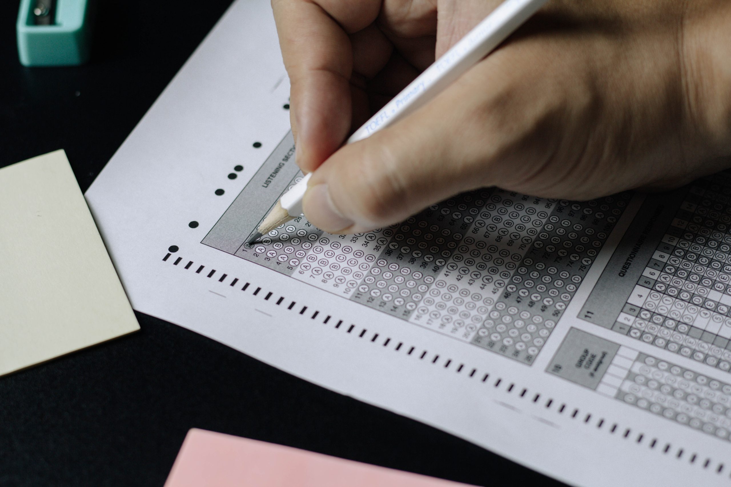 Person writing on white paper