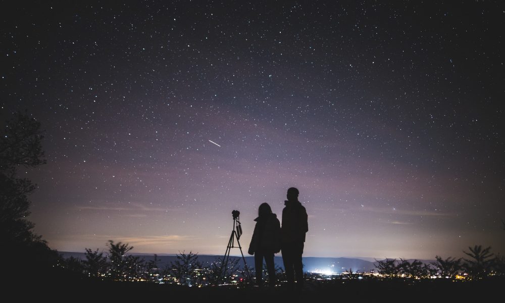 Silhouette of Two Persons Stargazing