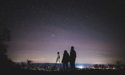 Silhouette of Two Persons Stargazing