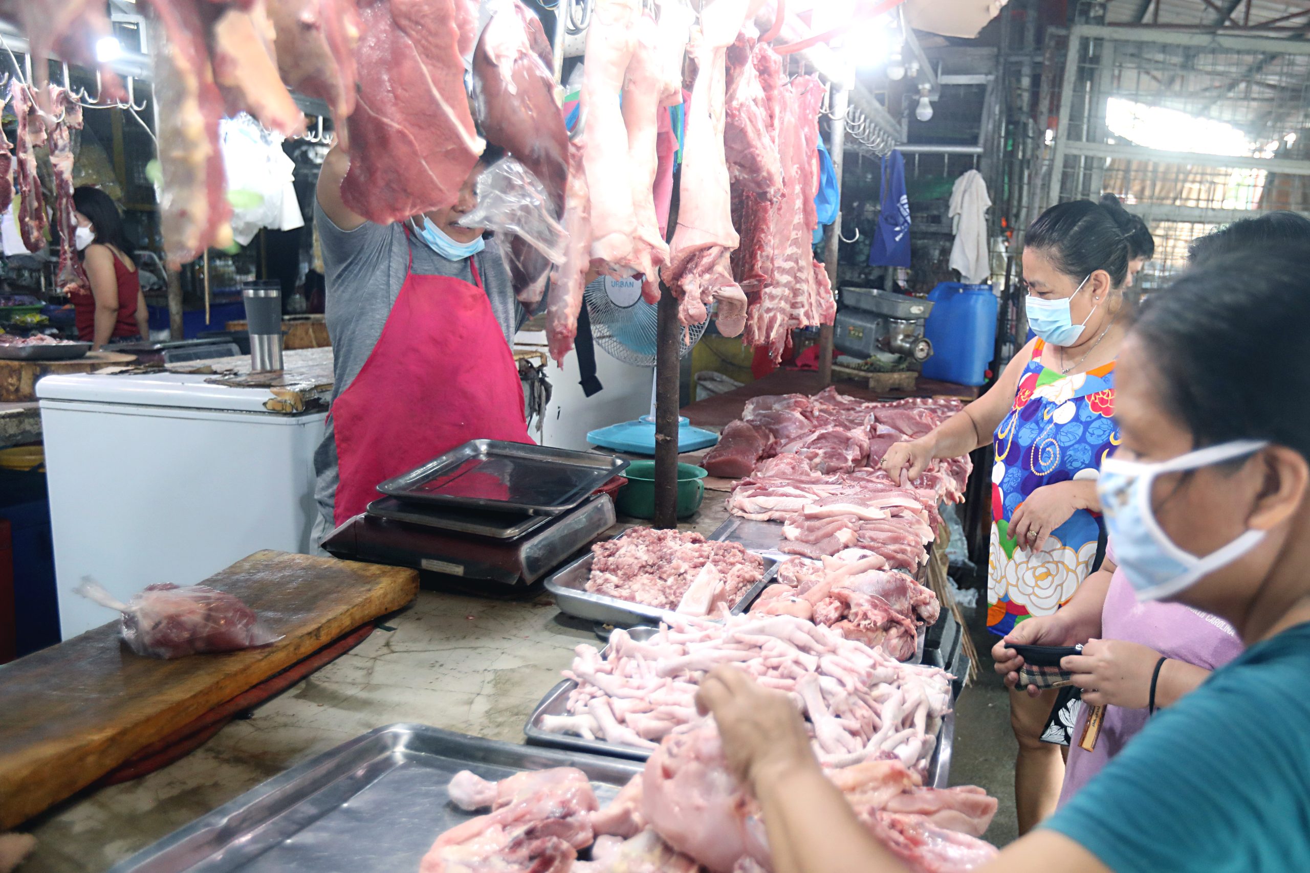 man selling meat to customers