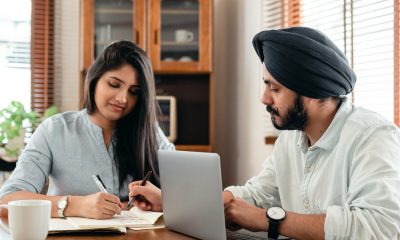 Focused tutor and student doing homework assignment using laptop