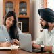 Focused tutor and student doing homework assignment using laptop