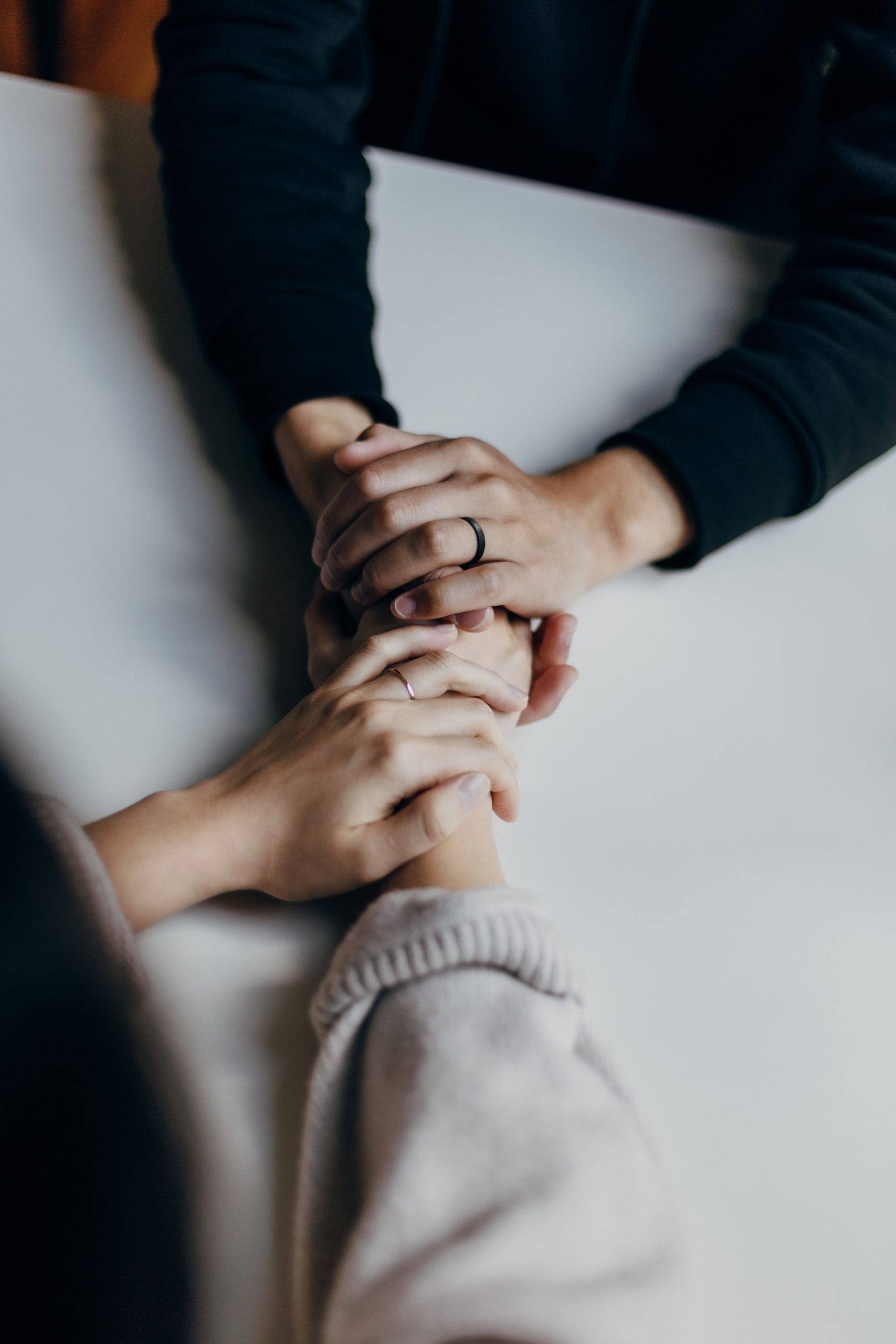 hands holding on white table