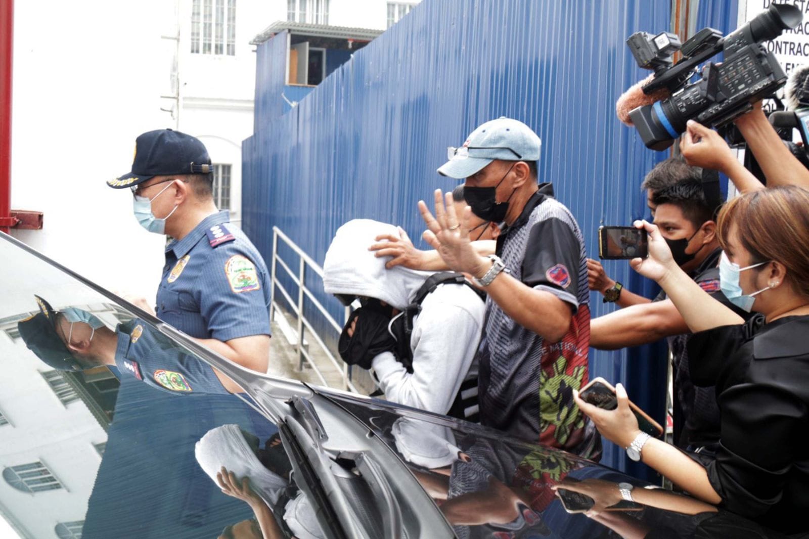 Joel Escorial escorted by police