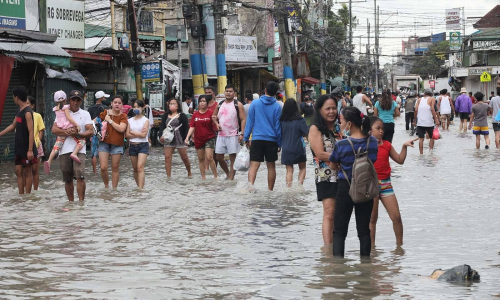 people walking through the flood