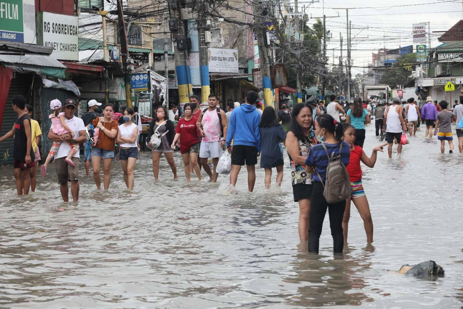 people walking through the flood