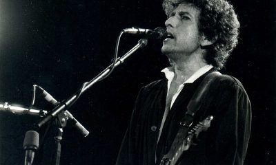 Bob Dylan playing guitar and singing