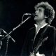 Bob Dylan playing guitar and singing