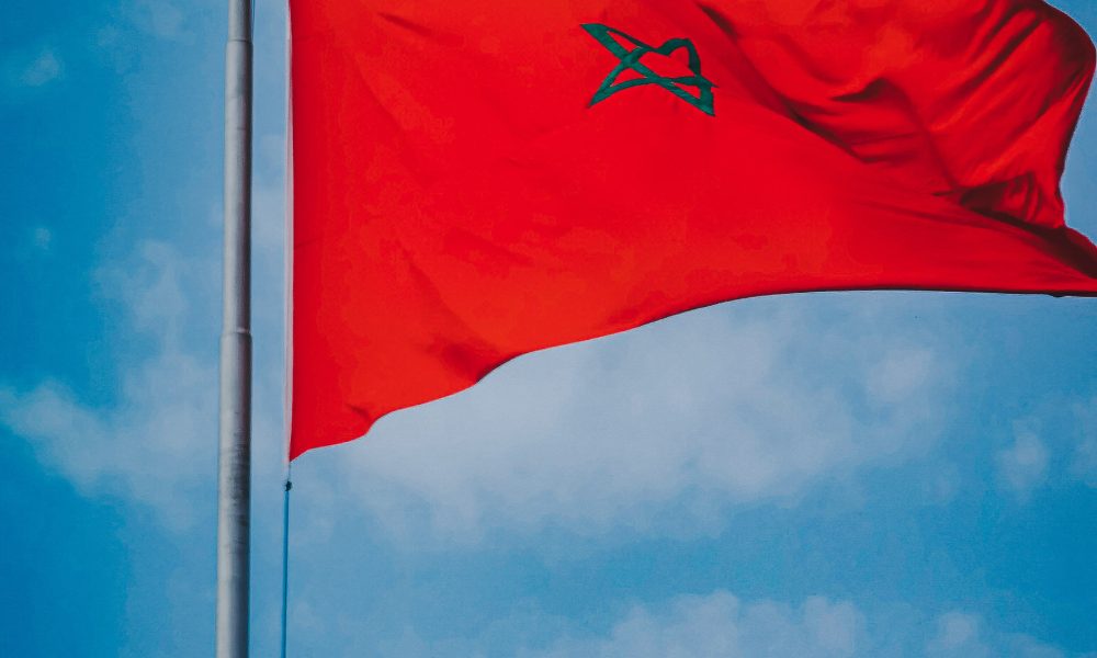 Flag of Morocco under a Cloudy Sky